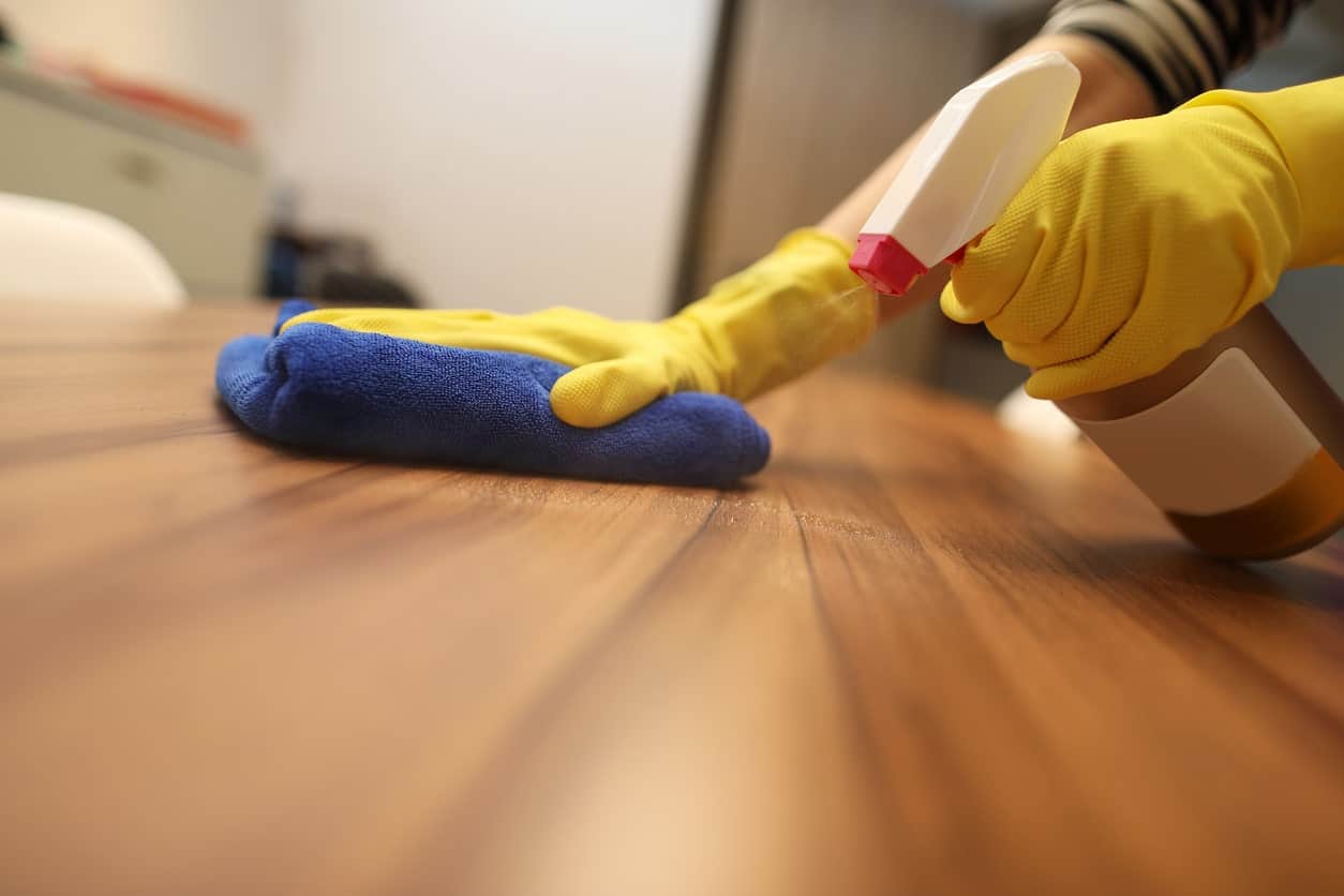 cleaner wiping down workspace